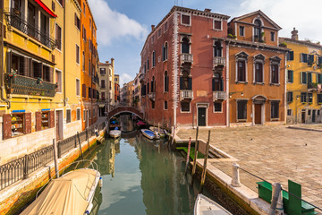 Canals of Venice city with boats and traditional colorful architecture, Italy