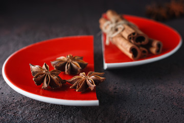 cinnamon and anise on a red split plate.