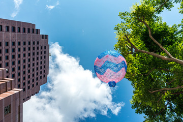 Christmas ornaments mysteriously floating in the air along public streets