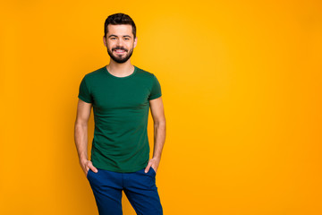Portrait of cheerful guy have spring holidays put hands pockets wear casual style clothes isolated over yellow color background