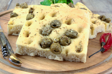 foccacia with olives on a cutting board