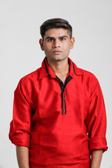 Indian / Asian man in red shirt and showing multi pal expression over white background 