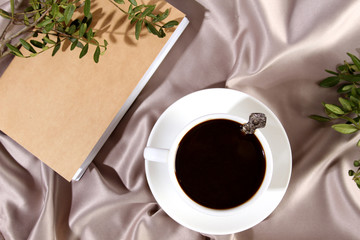 White cup of coffee with a notepad. Elegantly