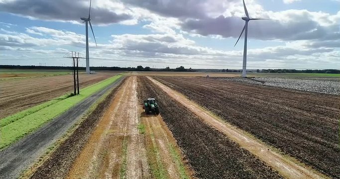 An aerial view of a tractor tilling the land following the harvest and prepare for the next crop to be drilled.