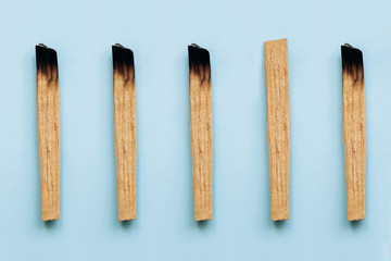 Palo Santo sticks on a blue background. They are used in aromatherapy and religious rites and meditations.