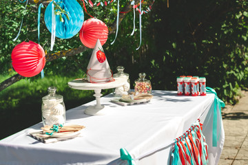 Preparing for the holiday and decorating the garden with balls and colored ribbons. Children's...
