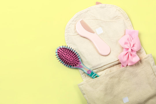 Little Girl's Backpack With Hair Accessories Flat Lay On Bright Yellow Background With Text Space