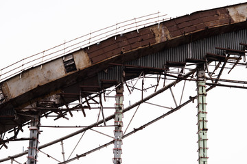 Demolition of the arena. Old metal frame of the building, destroyed walls.