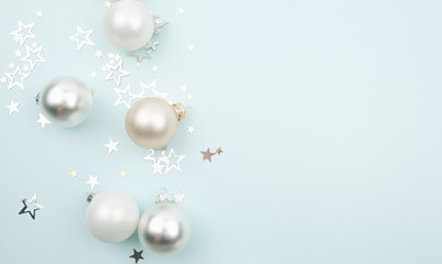 Fototapeta na wymiar christmas balls and stars on light blue background