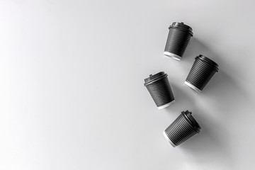 black paper cup coffee on white table background