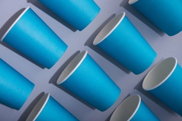 Paper cup of coffee on a pastel background