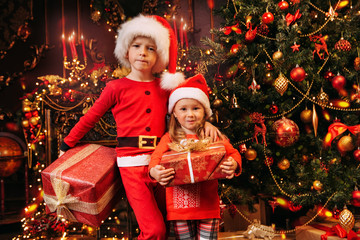 brother and sister in Christmas costumes