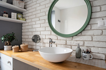 interior of Modern bathroom in industrial style in loft apartment. White brick wall, wooden...