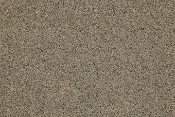 Mosaic and granulated textured coating, texture, background. Structural plaster, rough, uneven surface in brown color. Modern exterior cladding of multi-story buildings