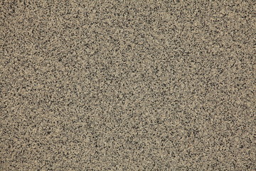 Mosaic and granulated textured coating, texture, background. Structural plaster, rough, uneven surface in brown color. Modern exterior cladding of multi-story buildings