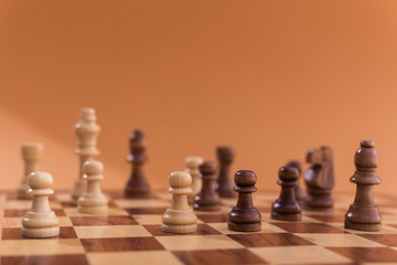 Wooden chess pieces on a chessboard