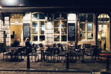 Old street with tables of cafe in center of Brussels, Belgium. Night cityscape of Brussels...