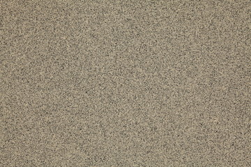 Mosaic and granulated textured coating, texture, background. Structural plaster, rough, uneven surface in brown color. Modern exterior cladding of multi-story buildings