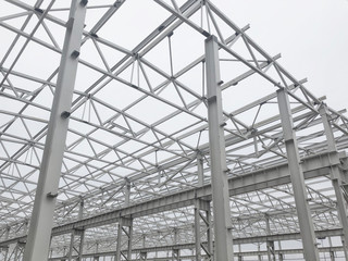 Truss ceiling and metal pillars and girders. Support constructions.