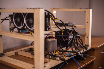 Video cards with on shelves connected to a farm for obtaining electronic money. Close-up. Out of focus. Blur