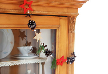 christmas background with an ornamental chain hanging on an old cabinet