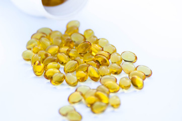 Vitamin D pills on a white background close-up.Yellow pills  isolated with a place for inscription.Nutritional supplements.
