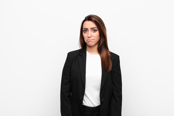 young pretty businesswoman feeling sad and whiney with an unhappy look, crying with a negative and...