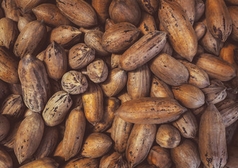 Background of pecan nuts - popular product in the diet of vegans and vegetarians.
