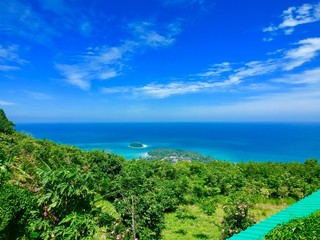 Panorama drone Aerial Views of Big Buddha Phuket Thailand turquoise blue waters white golden sandy beach lush green mountains 