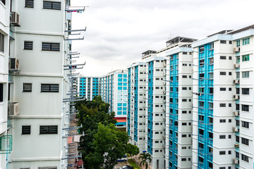Aerial view, on a cloudy day, of Public Housing Apartments in Singapore. Also known as HDB, these are government built vertical residential housing apartments.