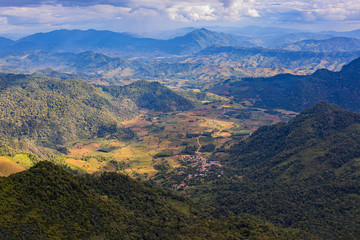 Fototapeta na wymiar Small village in the middle of the valley in Laos, when viewed from the Thai side