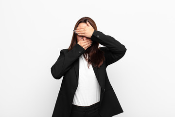 young pretty businesswoman covering face with both hands saying no to the camera! refusing pictures...