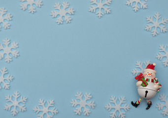 Christmas blue background with Christmas decorations and white snowflakes. New Year greeting card. Flat lay style. 