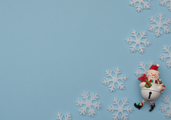 Christmas blue background with Christmas decorations and white snowflakes. New Year greeting card. Flat lay style. 