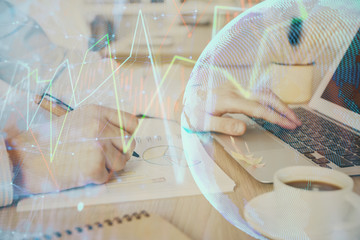 Multi exposure of stock market graph with man working on laptop on background. Concept of financial analysis.