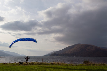 Man with a parachute and a dog, Fort William, Scotland