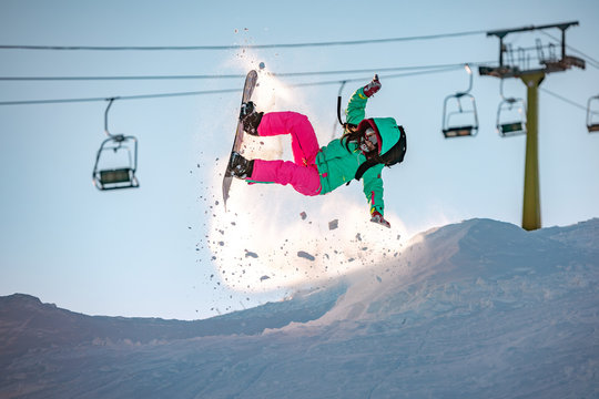 Girl Snowboarder Jumps And Fails On Snowboard