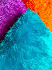 Soft fur background in shades of blue, orange and pink