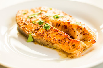 cook salmon in white plate with honey and mustard