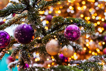 Outdoor vintage decorated Christmas tree with light garland, selective focus