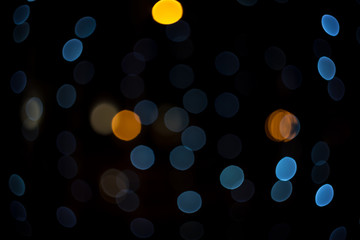 Fabulous bokeh of moderate blue circles combined with orange. Abstract festive background for banner.