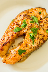 cook salmon in white plate with honey and mustard