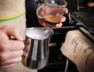 Fototapeta na wymiar Making coffee in coffeeshop or cafe closeup