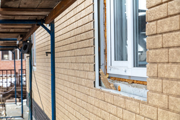 Fototapeta premium Installation of siding on the walls of the house