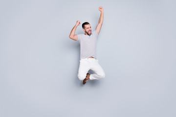 Fototapeta na wymiar Full length body size view of his he nice attractive sportive cheerful cheery glad fit bearded guy jumping up rejoicing isolated over light grey pastel color background