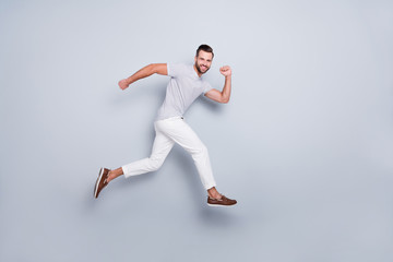 Full length body size view of his he nice attractive sportive cheerful cheery purposeful strong bearded guy running fast discount isolated over light grey pastel color background