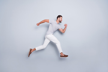 Fototapeta na wymiar Full length body size view of his he nice attractive muscular sportive cheerful strong bearded guy running fast hurry-up isolated over light grey pastel color background
