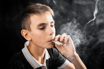 A teen Smoking a cigarette or drugs is a rolled dollar, the concept of teen addiction and spending...