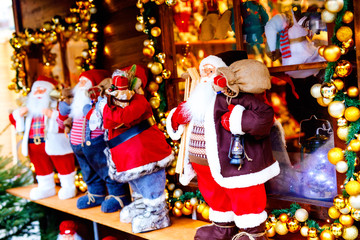 christmas market in Germany cute Santa Clause called Weihnachtsmann in German decoration, gifts, Xmas tree balls and illumination for sale