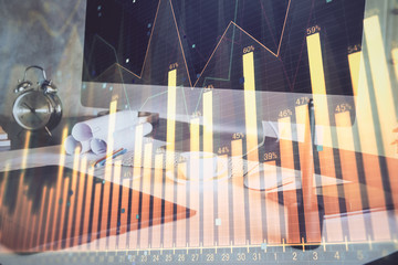 Stock market graph and table with computer background. Double exposure. Concept of financial analysis.